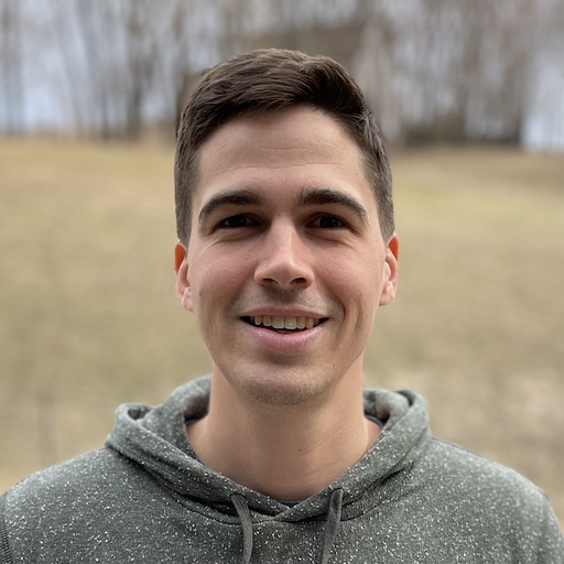 Kyle, smiling, in a grey hoodie